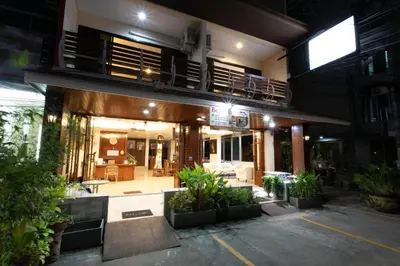 a building with a lot of plants in front of it at Best Venue Hotel in Patong Beach