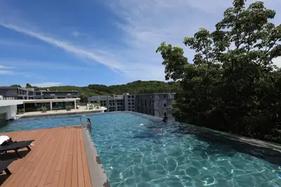 a large swimming pool on top of a building at 1 bdr apartment in Utopia Naiharn by Capital pro in Phuket Town