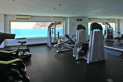 a gym with several treadmills and cardio machines at 1 bdr apartment in Utopia Naiharn by Capital pro in Phuket Town