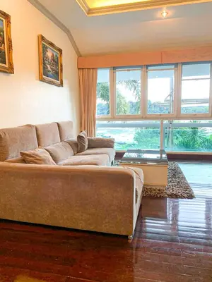a living room with a couch and a large window at Poolvillapanwa in Panwa Beach