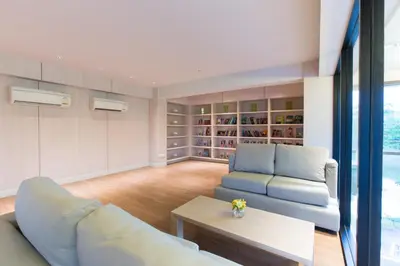 a living room with a couch and a table at Sugar Palm Residence in Phuket Town