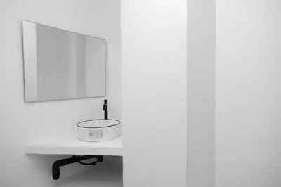 a white bathroom with a sink and a mirror at MoonE in Karon Beach