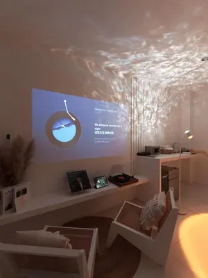 a living room with a large screen in the ceiling at MoonE in Karon Beach