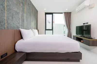 a bedroom with a large white bed and a tv at Scenic Seaview 270 Panorama, 2BR Penthouse VV Patong C701 in Patong Beach