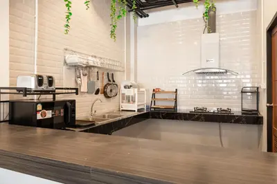 a kitchen with a sink and a counter at Marco Polo Phuket Poshtel & Bistro in Phuket Town