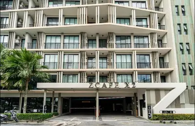 a large building with a sign on the front of it at Cozy 1 bedroom in prime Bangtao in Bang Tao Beach