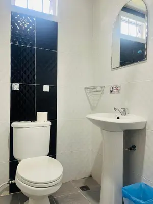 a bathroom with a white toilet and a sink at Rest Mind House in Surin Beach