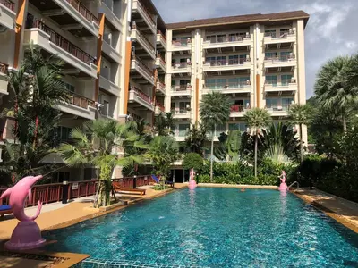 a swimming pool in front of a large building at Phuket Villa Patong- Pool View in Patong Beach