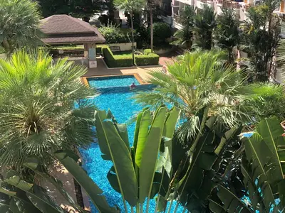 a resort pool with palm trees and a gazebo at Phuket Villa Patong- Pool View in Patong Beach