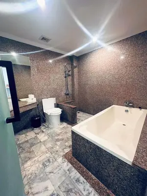 a bathroom with a bath tub and a toilet at Ocean Pie Phuket - Adult Only in Rawai Beach