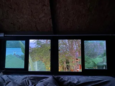 a view of three windows in a bedroom at Phi Phi Goodview Bungalow in Phi Phi Don