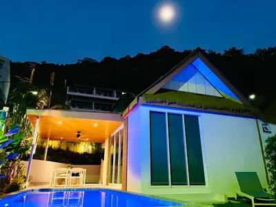 a house with a swimming pool in front of it at Baan Saint-Tropez Seaview Villas Kata Beach in Kata Beach