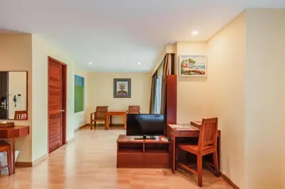 a living room with a desk and a television at Elite Suites Patong in Patong Beach