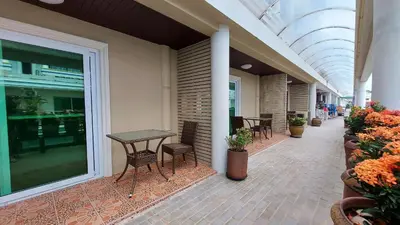 a hallway with tables and chairs in a building at Sawasdee Apartment Patong in Patong Beach