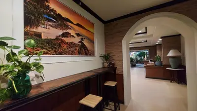 a hallway with a large painting on the wall at Sawasdee Apartment Patong in Patong Beach