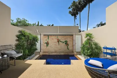 a backyard with a swimming pool and a brick wall at Villa 242 - private pool, fast internet in Ban Thalat Choeng Thale