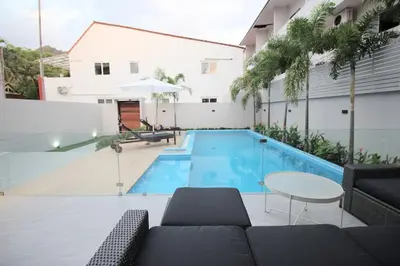 a swimming pool with a couch and a table at Stylish Pool Villa - 10 Minutes walk to the Beach in Kamala Beach