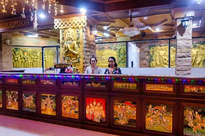 two women standing behind a bar at a restaurant at Diva Patong Hotel in Patong Beach