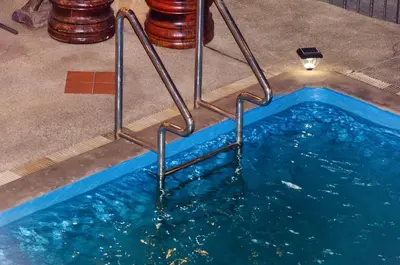 a pool of water with stairs in the floor at Diva Patong Hotel in Patong Beach