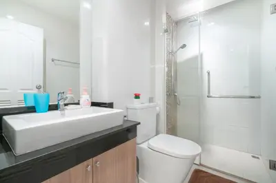 a bathroom with a sink and a toilet and a shower at The Lago Apartments in Ban Suan