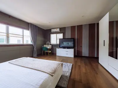 a bedroom with a bed and a flat screen tv at Grand Penthouse by Grand Orlov Apart in Patong Beach
