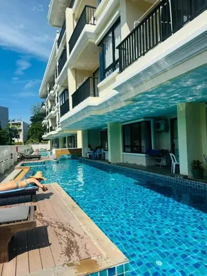 a swimming pool in front of a building at 2 bed room the lago naiharn beach in Nai Harn Beach