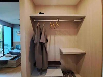 a closet with hangers and shoes in a room at Zcape1 boat avenue in Ban Thalat Choeng Thale