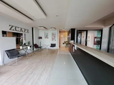 an empty lobby with chairs and tables in a building at Zcape1 boat avenue in Ban Thalat Choeng Thale