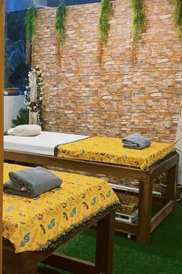 two beds sitting in front of a brick wall at Sasimanta in Kamala Beach
