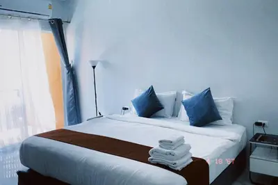 a bedroom with a bed with towels on it at Sasimanta in Kamala Beach