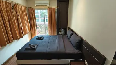 a small bed in a room with a window at Phuket Villa Patong Beach by Naphat in Patong Beach