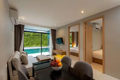 a living room with a couch and a table at Wyndham Garden Naithon Phuket in Nai Thon Beach