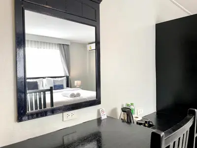 a bathroom with a large mirror on the wall at Minotel Patong in Patong Beach