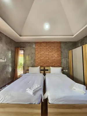 two beds sitting next to each other in a bedroom at The Beatles Lagoon in Ban Na Bon