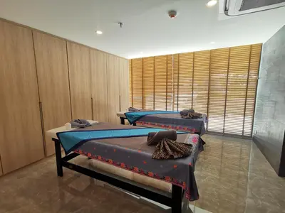 two beds in a room with wooden cabinets at Water park Rawai Beach 200m Nai Han king bedroom in Rawai Beach
