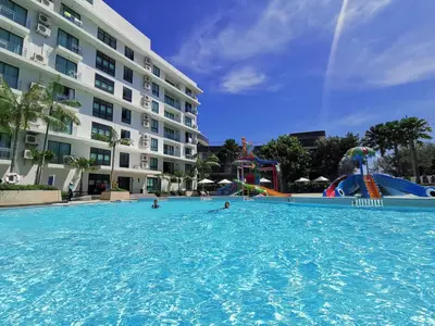 a large swimming pool in front of a large building at Water park Rawai Beach 200m Nai Han king bedroom in Rawai Beach