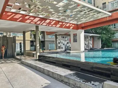 a large swimming pool in a building at Dcondo Kathu - Top Floor 1 Bdr Condo with shared Pool in Kathu