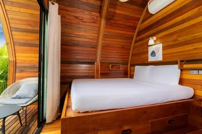 a bed in a room with a wooden wall at Tropical Chalet 2BR Villa Pasak Paradise 1 with Private Pool, Laguna 10 min drive in Bang Tao Beach