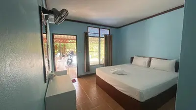 a bedroom with a white bed and a window at Adam Bungalows in Ao Nang Beach