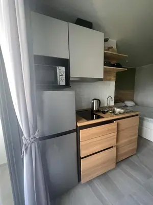 a kitchen with a stainless steel refrigerator and a sink at The Tower Condo Phase3 in Ban Klang