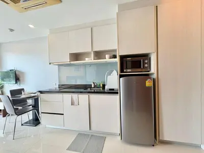 a kitchen with a refrigerator and a counter top at 1 Bedroom Rawai Walk to beach in Rawai Beach