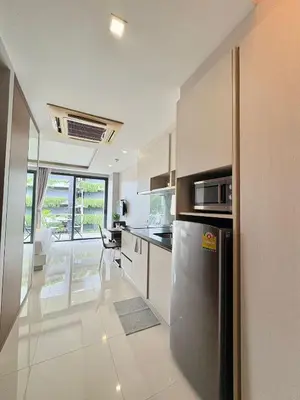 a kitchen with stainless steel appliances and a balcony at 1 Bedroom Rawai Walk to beach in Rawai Beach