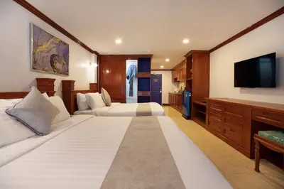 a hotel room with two beds and a flat screen tv at Aspira Resort Klong Muang Krabi in Klong Muang Beach