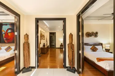 a bedroom with two beds and a mirror at Secret Balinese Escape villla Eva in Rawai Beach