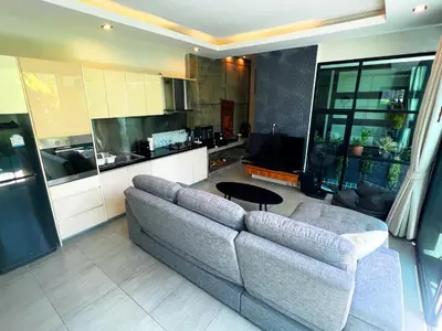 a living room with a couch and a kitchen at Intimate Oasis, 2 bedrooms Pool in Kata Beach