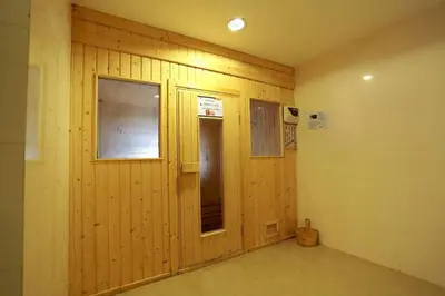 a room with a wooden wall with two windows at Quiet Patong Apartment near Night Life & Good Food in Patong Beach
