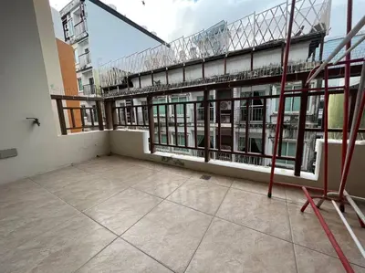 an empty balcony of a building with windows at Quiet Patong Apartment near Night Life & Good Food in Patong Beach