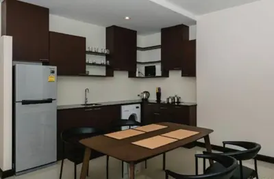 a kitchen with a table and chairs and a refrigerator at Апартаменты с видом на море на Карон Бич А 409 in Karon Beach
