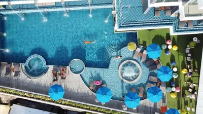 an overhead view of a swimming pool with umbrellas at The Yama Hotel Phuket in Kata Beach