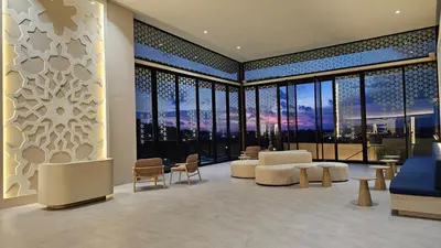 a living room with a view of a city at The Yama Hotel Phuket in Kata Beach